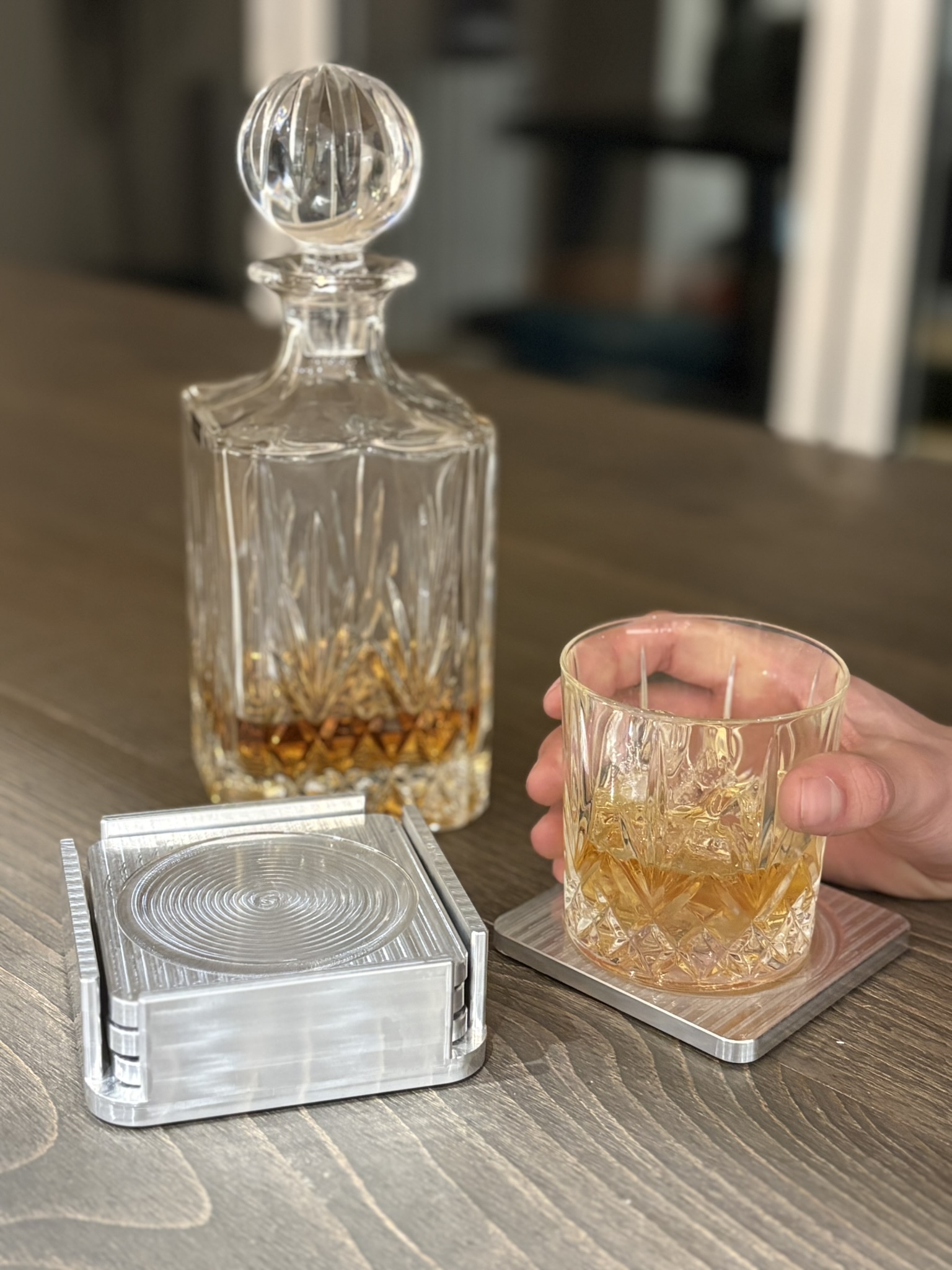 A machined aluminium coaster set in use