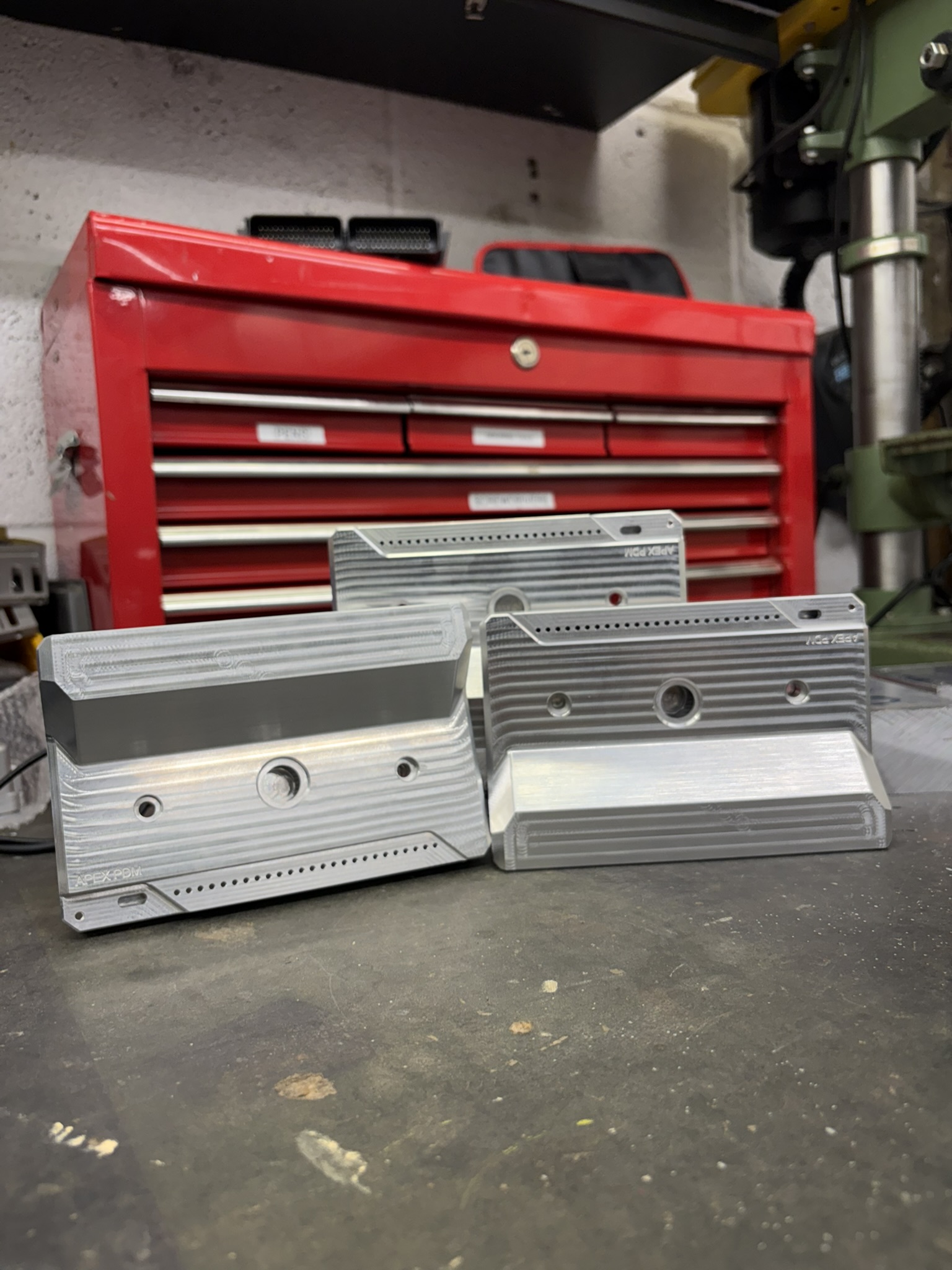 Three machined aluminium electronics enclosures in the Cley CNC workshop