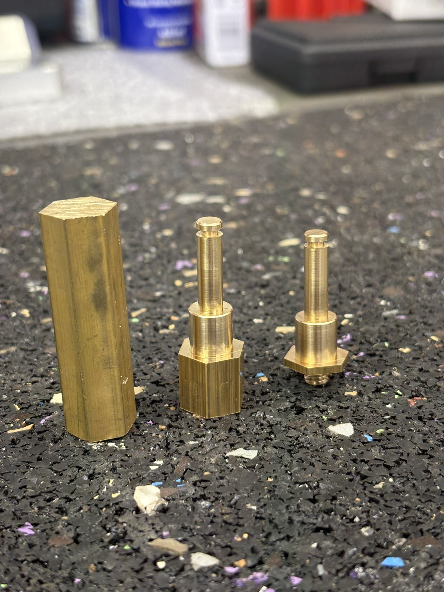 Brass stock and Radlok pins at different machining stages